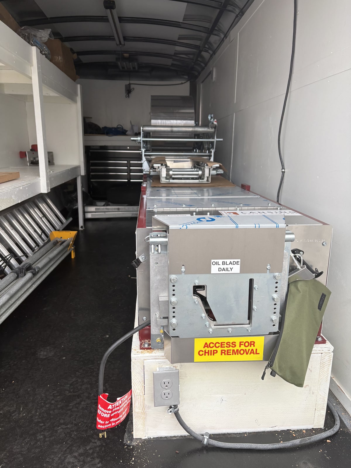 Kearleys Exteriors seamless gutter fabrication machine inside the production trailer.